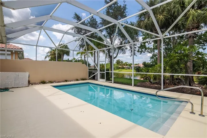 View of swimming pool with a patio area with water background