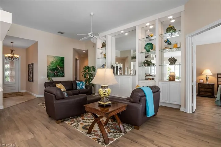 Living room featuring built in features, open to kitchen