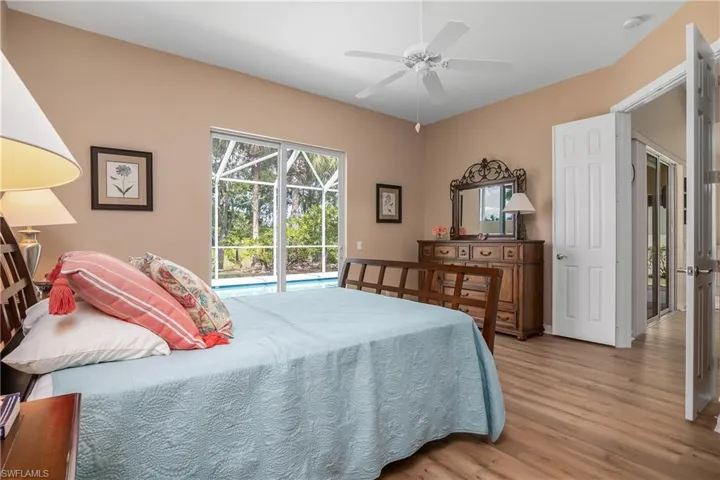 Primary Bedroom with ceiling fan, engineered waterproof flooring, and access to outside