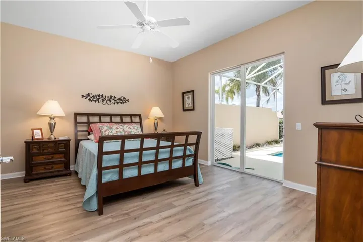 Primary Bedroom featuring ceiling fan, access to exterio ,and an abundance of closet space