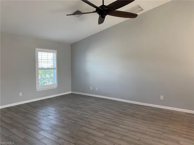 Unfurnished room featuring wood finish floors and a ceiling fan