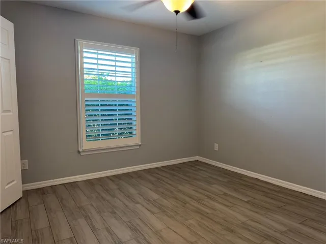 Spare room featuring wood finished floors and a ceiling fan