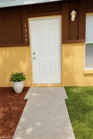 View of exterior entry featuring stucco siding