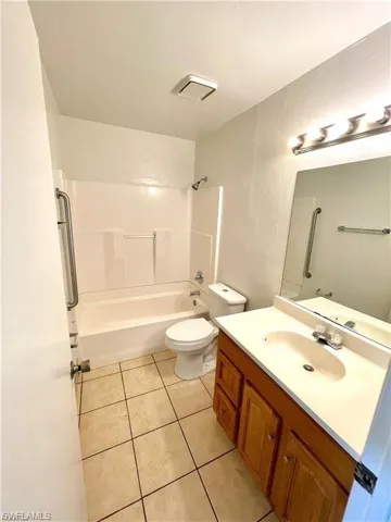 Full bathroom featuring vanity,  shower combination, and light tile patterned floors
