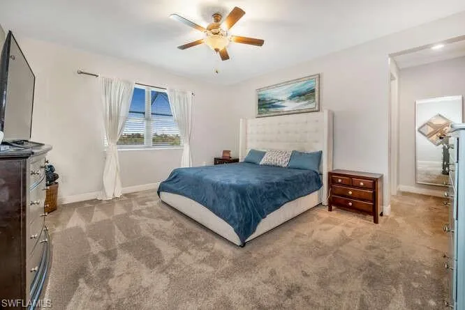 Bedroom featuring carpet flooring and ceiling fan