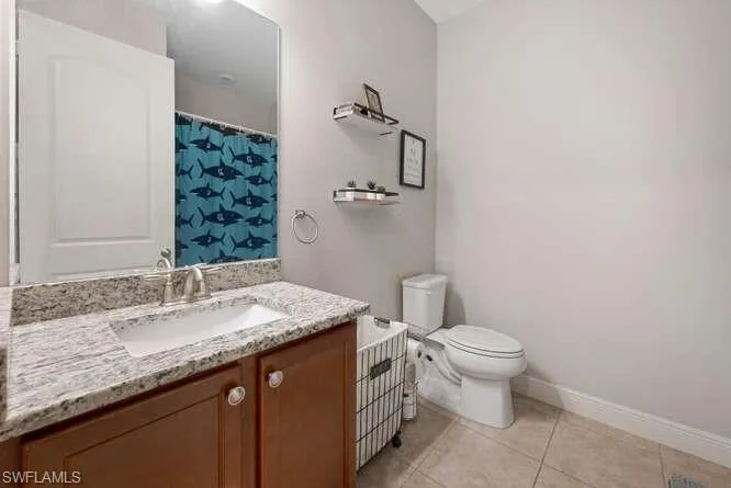 Full bathroom with vanity and tile patterned floors