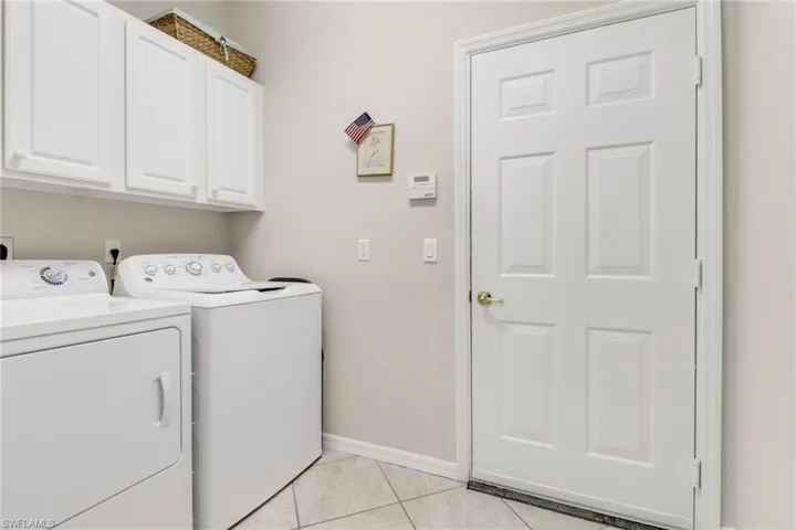 Laundry room with cabinets.