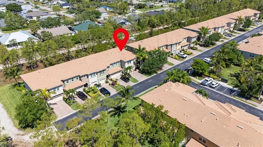 Aerial view of property and surrounding area featuring nearby suburban area