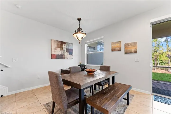 Dining area featuring light tile patterned floors and baseboards