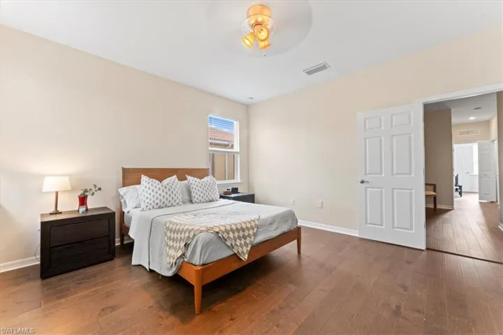 Bedroom featuring hardwood / wood-style flooring and baseboards
