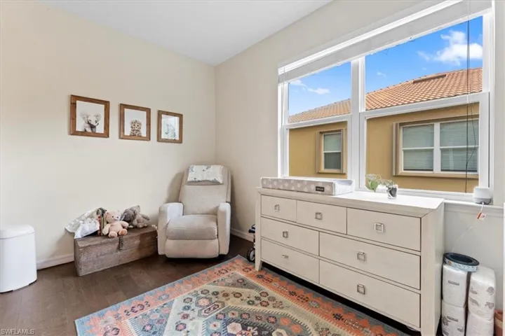 Living area with wood finished floors and baseboards