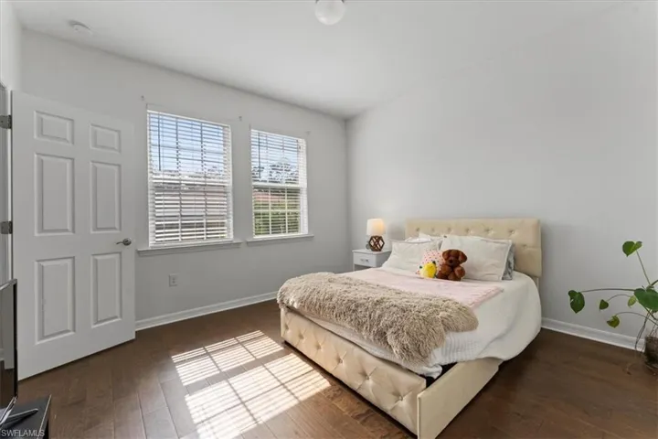 Bedroom with baseboards and wood finished floors