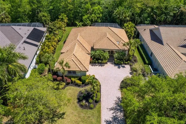 View from above of property with a tree filled landscape