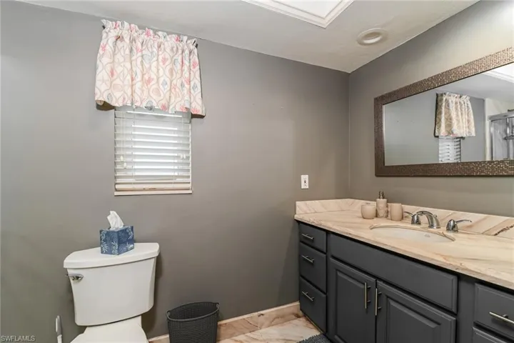 Bathroom featuring vanity and light marble finish floors