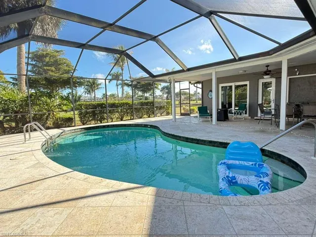 Swimming pool with a patio and a sunroom