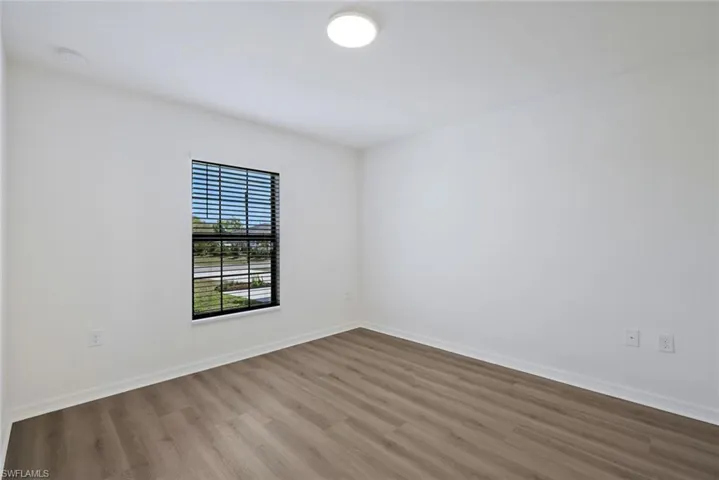 Spare room with wood finished floors and baseboards