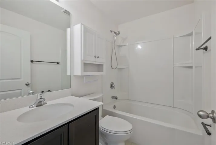 Bathroom with vanity and bathtub / shower combination