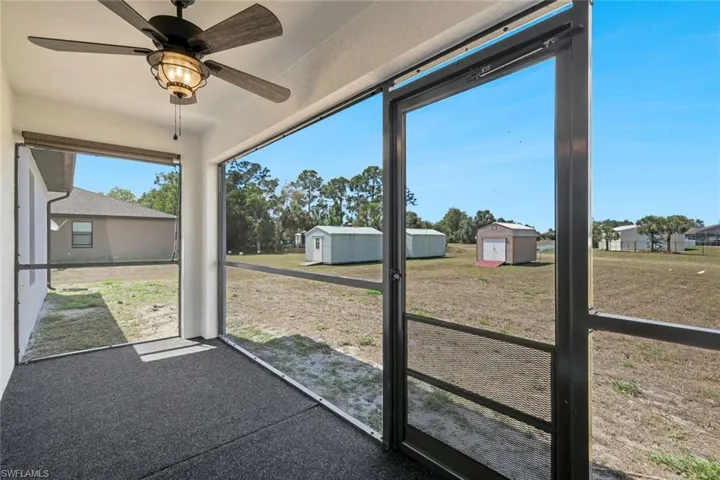 Unfurnished sunroom featuring a ceiling fan