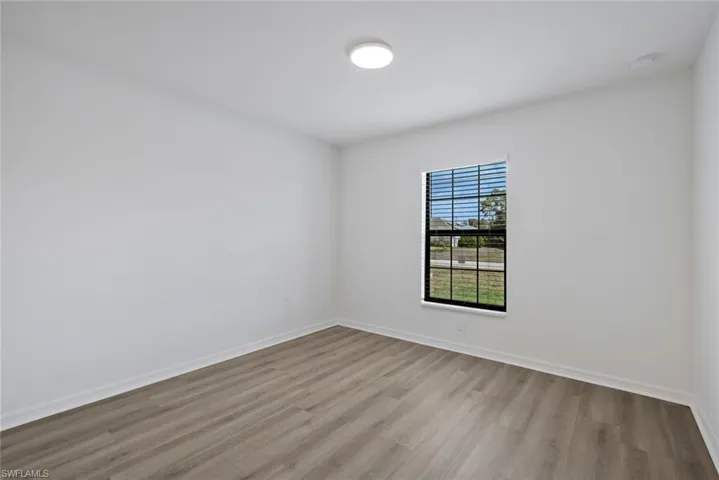 Unfurnished room featuring light wood-style flooring and baseboards