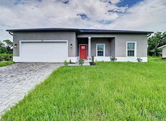 View of front facade with a front yard and a garage