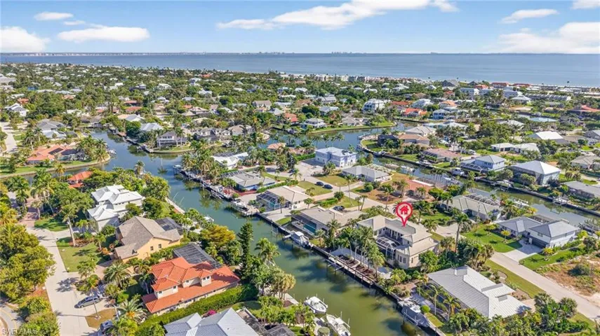 Aerial overview of property's location with nearby suburban area and a large body of water