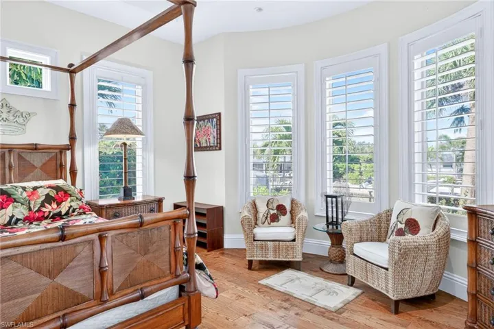 Bedroom with light wood finished floors and baseboards