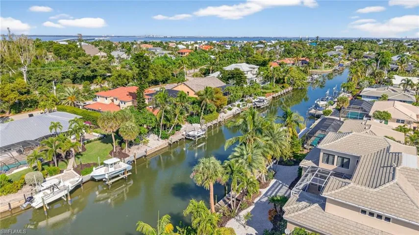 Aerial perspective of suburban area with a nearby body of water