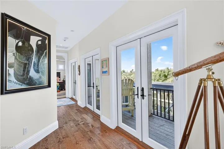 Doorway to outside with french doors, wood-type flooring, and healthy amount of natural light