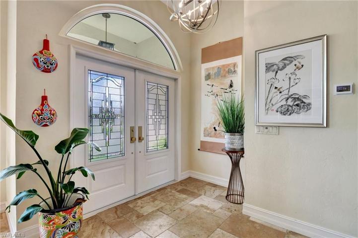 Stunning Leaded Glass Double Entry Doors opens to foyer.