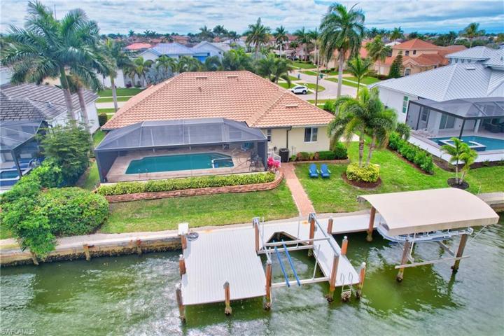 Dock and Double boat lifts, panoramic caged pool and a backyard!