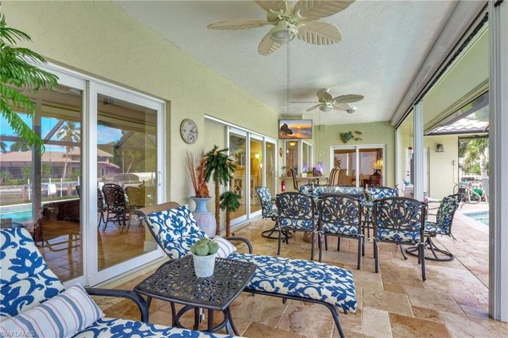 Wonderful outdoor living. Note Pocket Sliders from Master Bedrrom and Living Room, fans, TV, travertine tile...