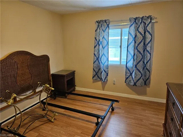 Bedroom with hardwood / wood-style floors