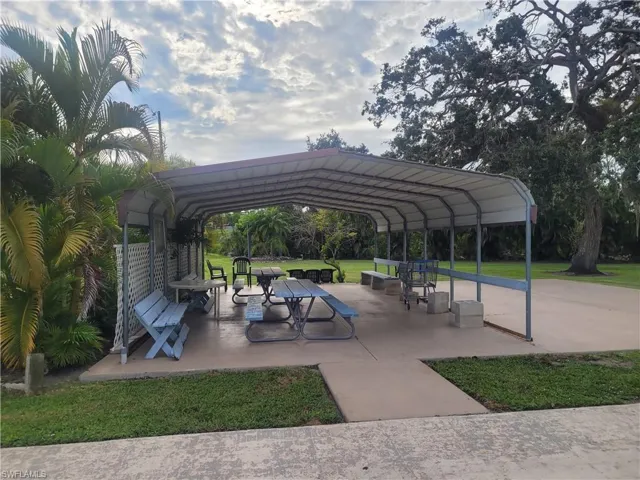 View of community with a patio and a lawn