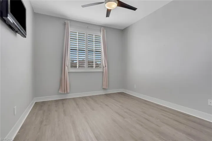 Empty room featuring light wood finished floors and a ceiling fan
