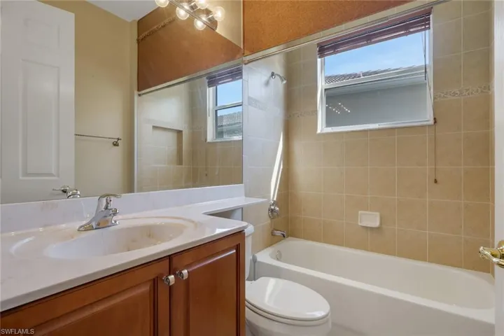 Bathroom with vanity and shower / washtub combination