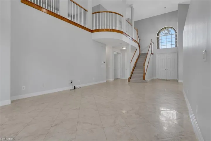 Foyer entrance featuring a high ceiling and baseboards