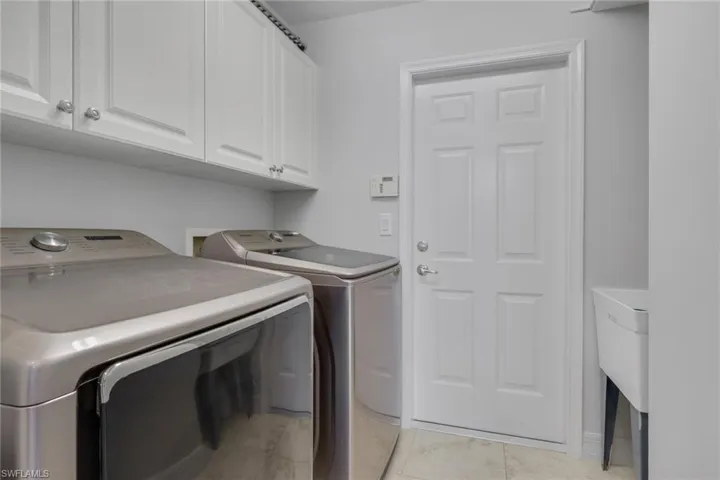 Laundry area with cabinet space and separate washer and dryer