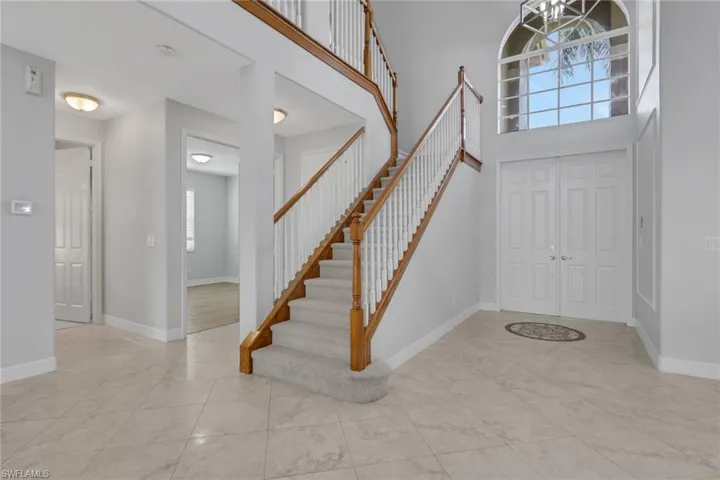 Foyer entrance featuring a high ceiling and hanging lights