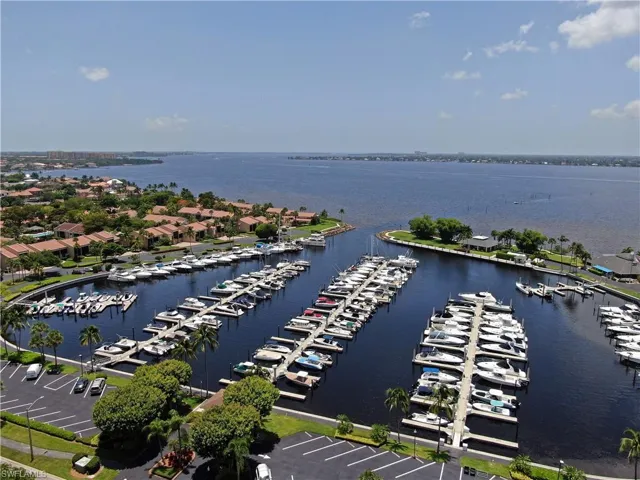 Birds eye view of property with a water view