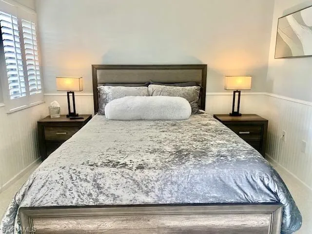 Bedroom featuring a wainscoted wall