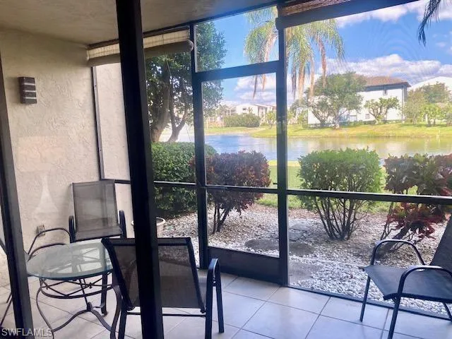 Sunroom featuring a water view