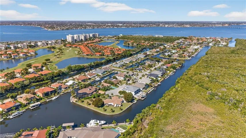 Aerial perspective of suburban area with a nearby body of water