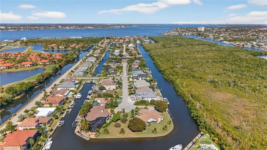 Aerial perspective of suburban area with a nearby body of water