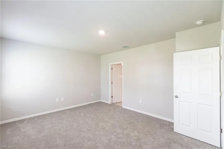 Spare room featuring carpet flooring