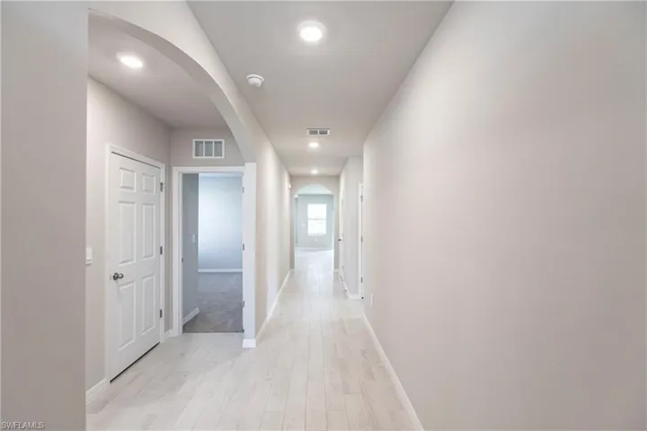 Hall with light hardwood / wood-style floors
