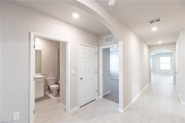 Hall featuring light colored carpet