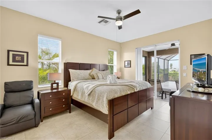 Bedroom featuring access to outside, ceiling fan, and light tile patterned floors