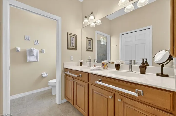 Bathroom featuring double vanity and tile patterned floors