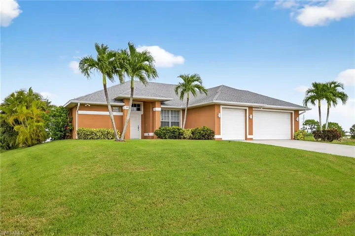 Ranch-style home with concrete driveway, a front lawn, stucco siding, a garage, and a shingled roof