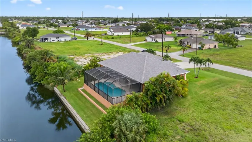 Aerial perspective of suburban area featuring a nearby body of water